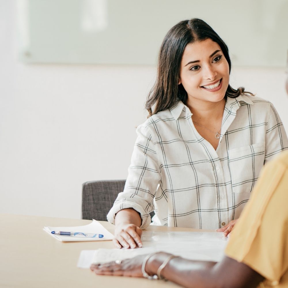 women discussing a resume
